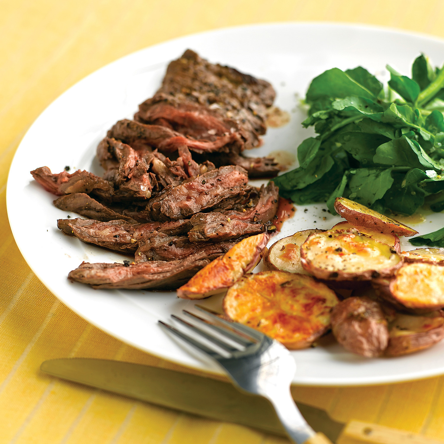 Skirt Steak with Crispy Garlic Potatoes Recipe | Martha Stewart