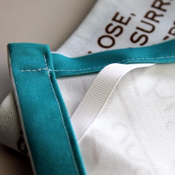 Sew a small length of twill tape sewn into the corner to hang your tea towel from a hook.