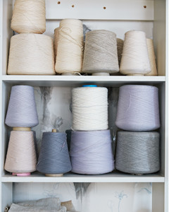 assorted spools of thread on white shelves