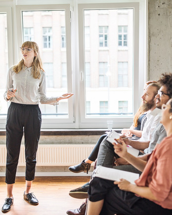 woman giving presentation in front of coworkers