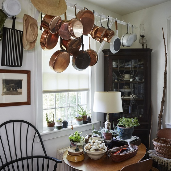long island home hanging pots and straw hat on chair