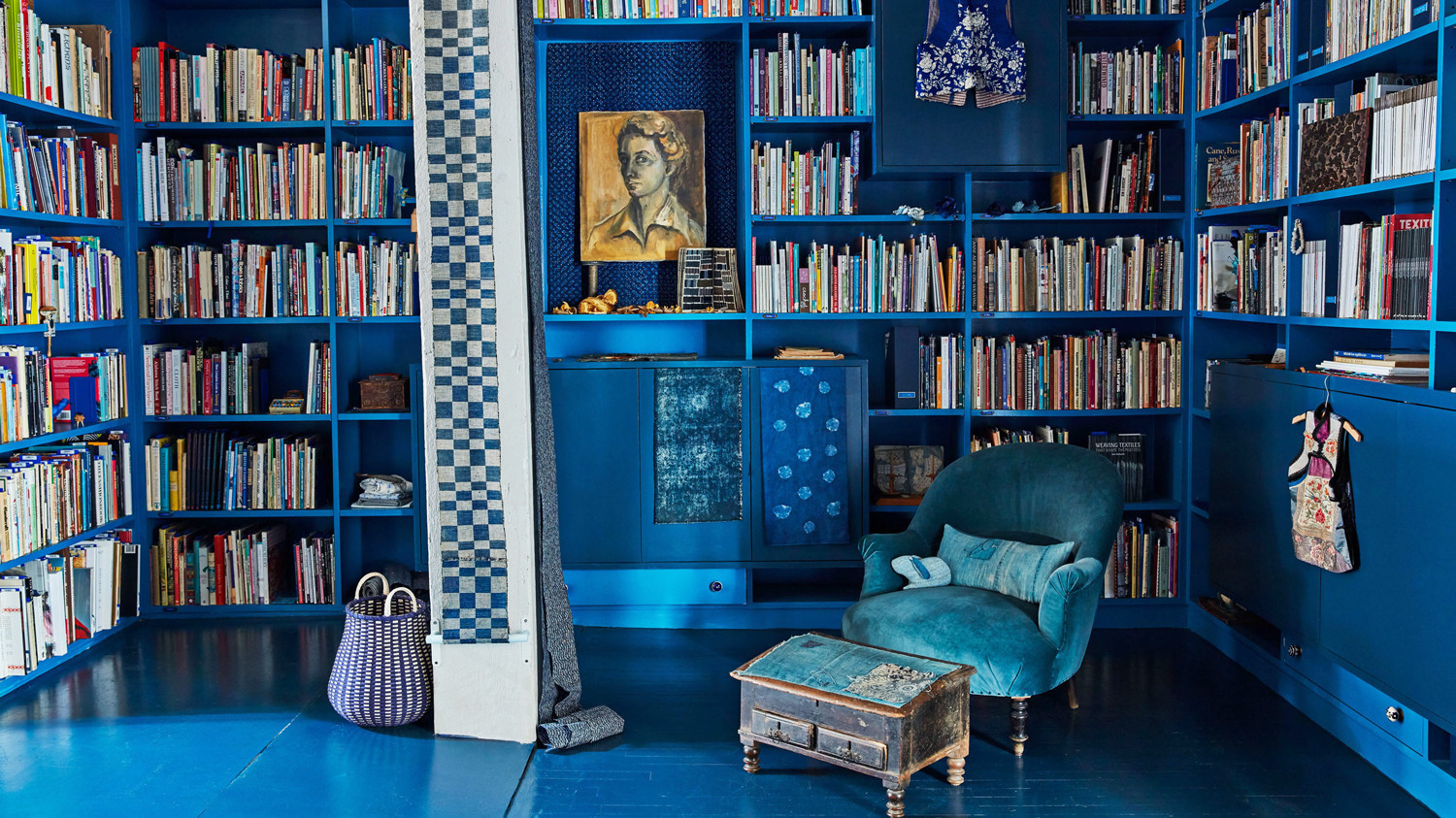 blue library with textiles hanging and handmade baskets