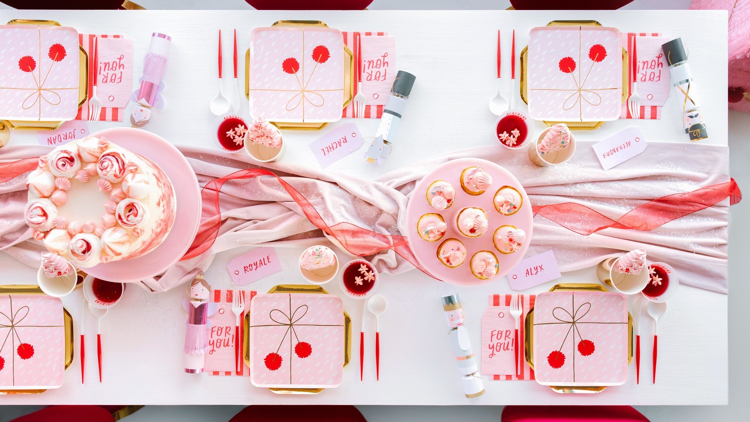 Host A Whimsical Christmas Party With Nuter Piñatas Martha Nuter Christmas Party Pink Red Table Setting With Cakes