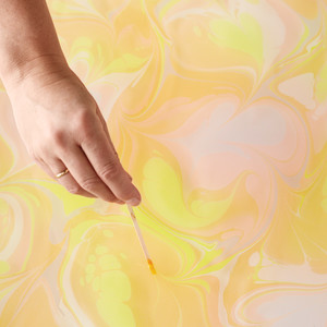 Drag stirrer through paint to add swirls and create designs; work over whole bin, or focus on specific areas.