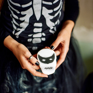 eli skeleton masquerade birthday party woman holding skull mask cookie