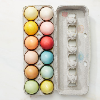 naturally dyed easter eggs in an egg carton