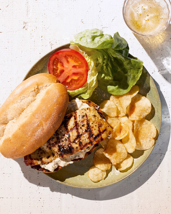 grilled salt-rubbed fish sandwich served with chips