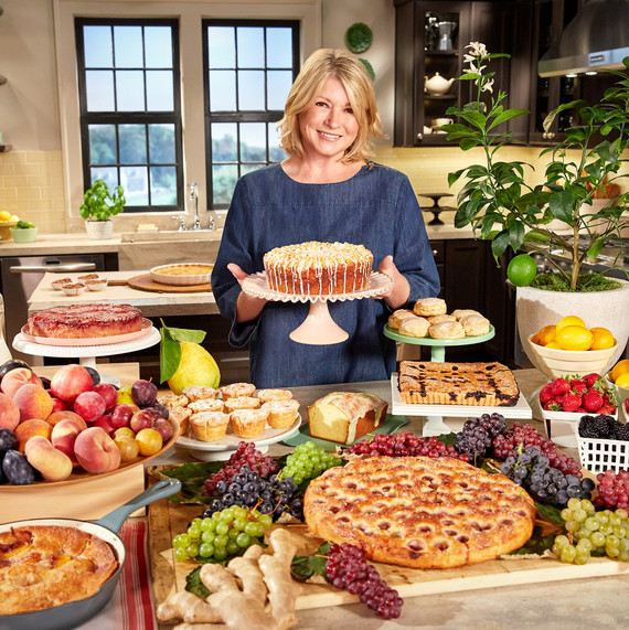 martha in kitchen holding cake surrounded by desserts martha in kitchen holding cake surrounded by desserts