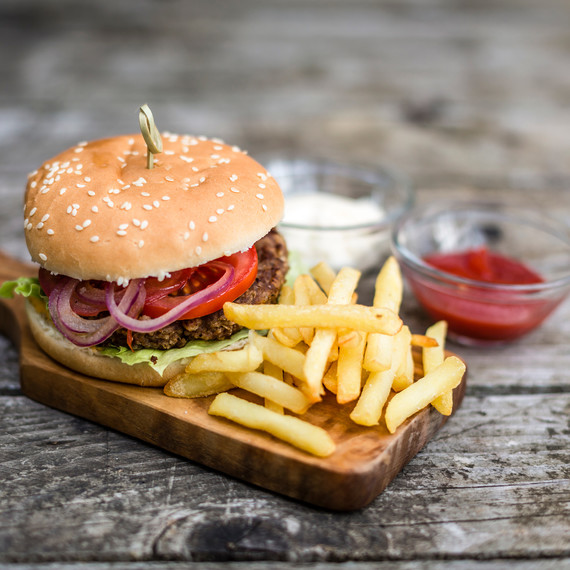 Grilled Hamburger with Fries and Condiments Grilled Hamburger with Fries and Condiments