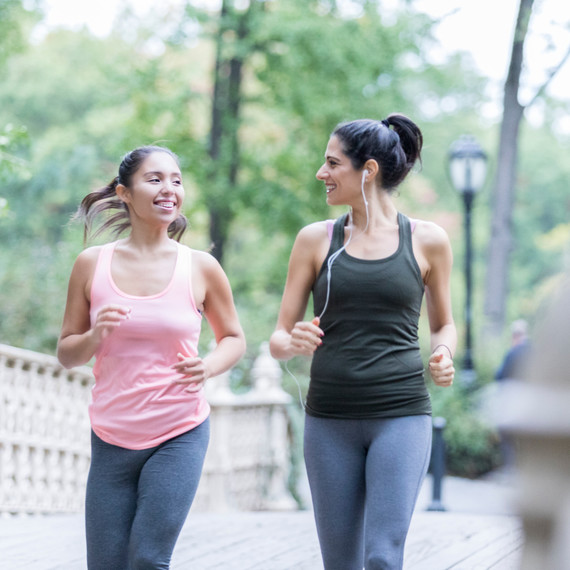 Two women walking in a park to exercise. Two women walking in a park to exercise.