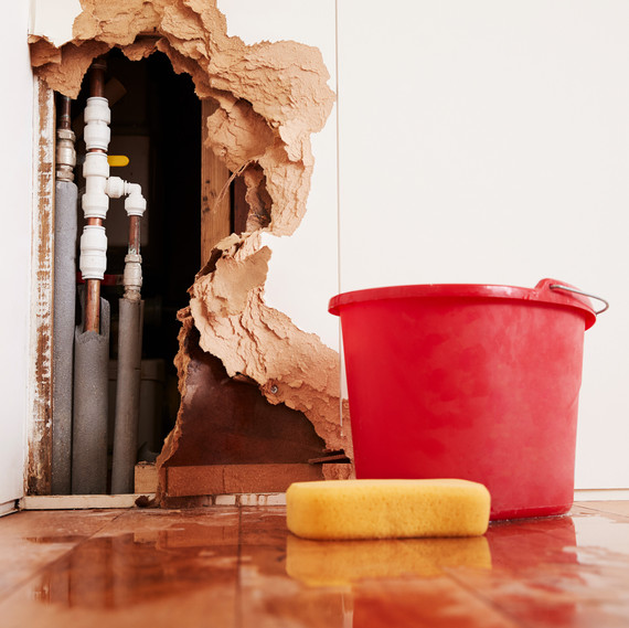 burst pipe causing damage in the home wall