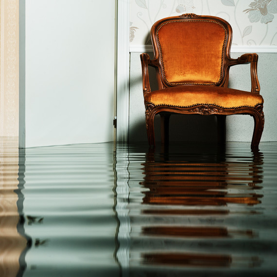 flooded living room with a chair in a home