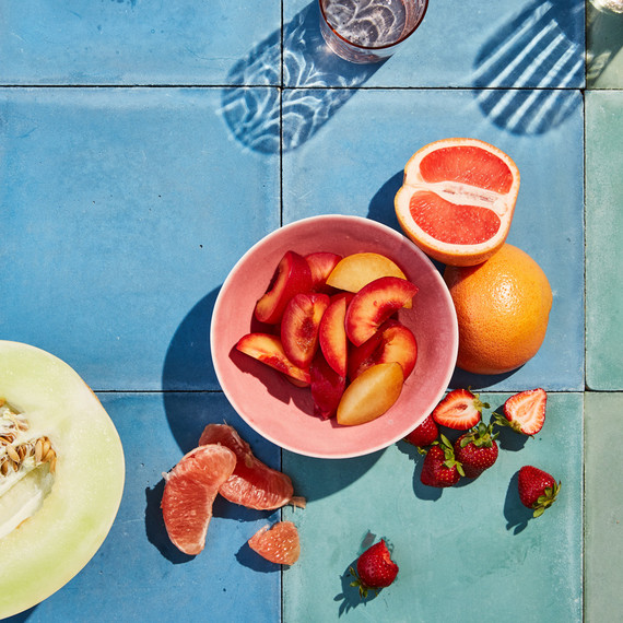 pink fruit and honey dew on blue tile pink fruit and honey dew on blue tile