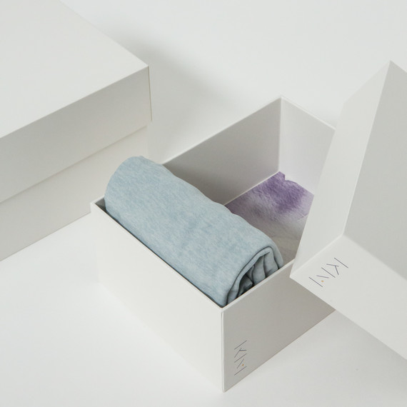 white marie kondo box with clothes folded in it white marie kondo box with clothes folded in it