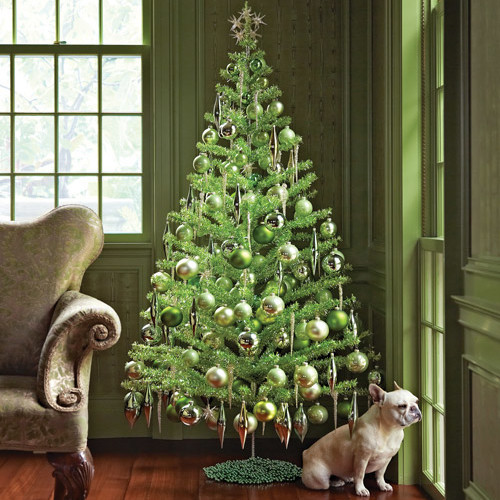 green christmas tree with bulldog by window green christmas tree with bulldog by window