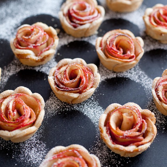 Dust mini rose apple pies with powdered sugar
