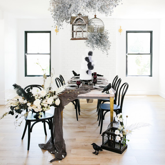 haunted movie house tablescape with black accents and bird birdcage motif