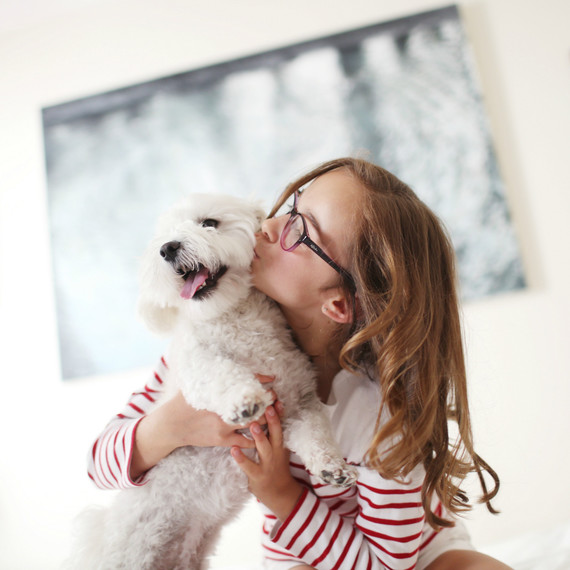 Young girl giving her pet dog a kiss Young girl giving her pet dog a kiss