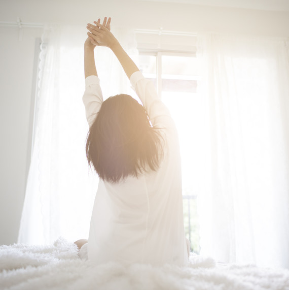 woman waking up to sun woman-waking-up-sunlight-0518