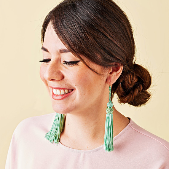 green fringe earrings on woman green fringe earrings on woman