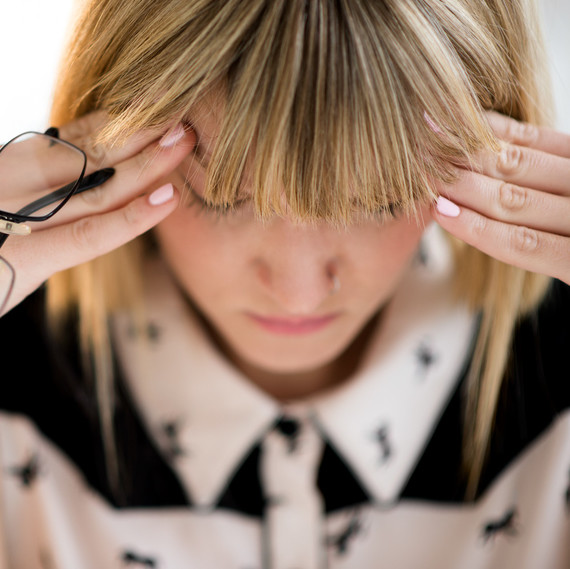 woman with headache hands on head woman with headache hands on head