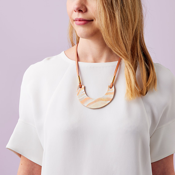 woman wearing clay pendant necklace woman wearing clay pendant necklace