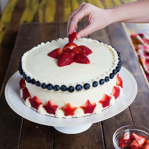 Arrange strawberries in a star pattern on top of cake