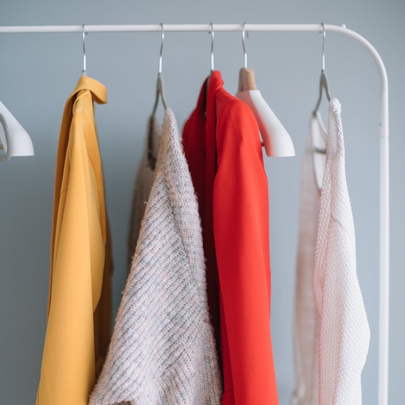 clothes hanging on a rack clothes hanging on a rack