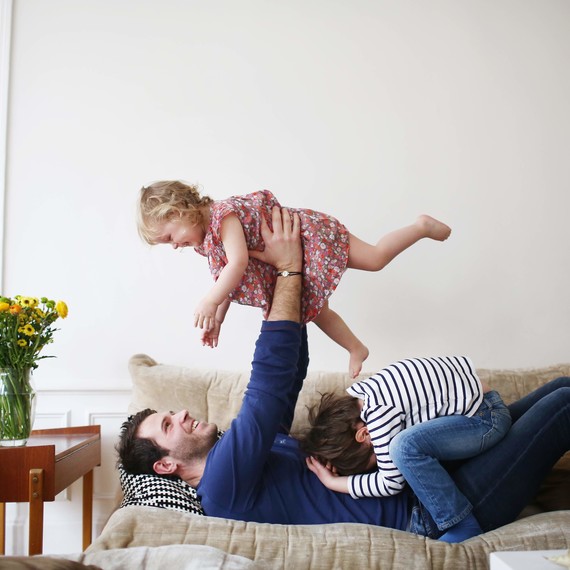 family playing on couch family playing on couch