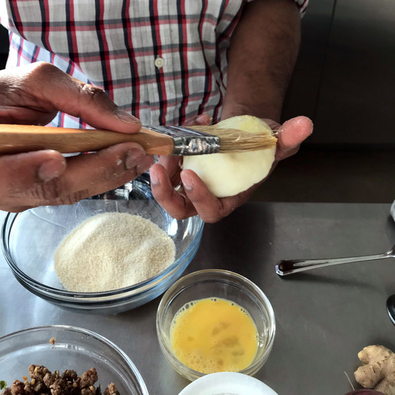 nik sharma brushing potato cake with egg yolk nik sharma brushing potato cake with egg yolk
