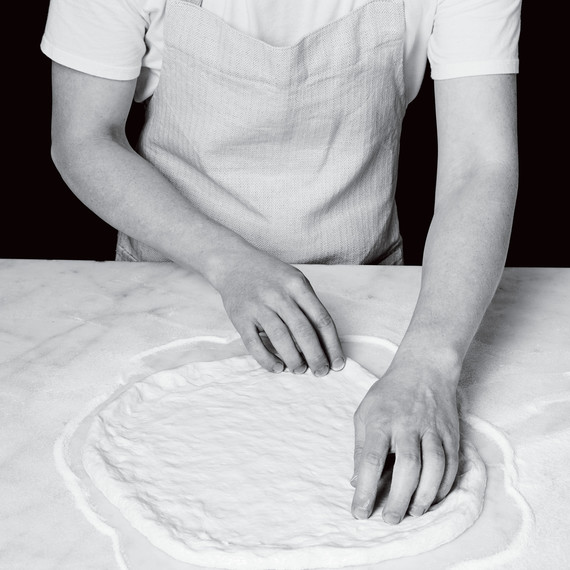 spreading out pizza dough spreading out pizza dough