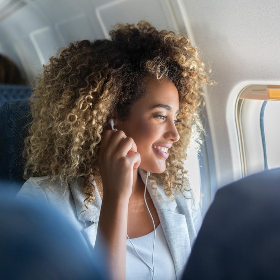 women on airplane flight looking out window women on airplane flight looking out window