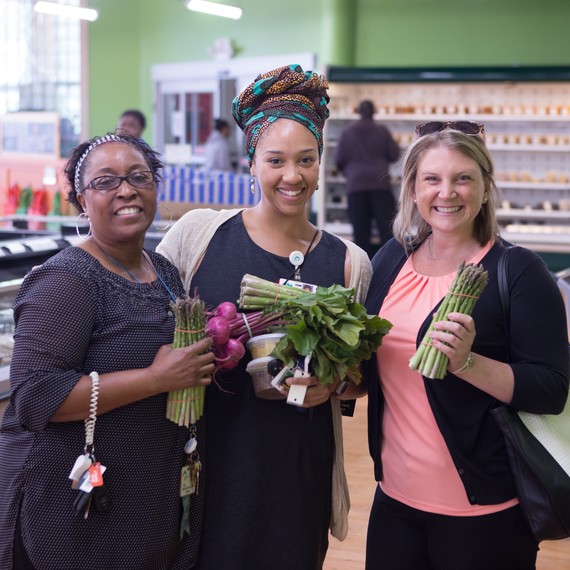 women with fresh produce at Daily Table store women with fresh produce at Daily Table store