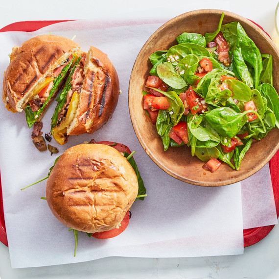 two burgers with spinach salad two burgers with spinach salad