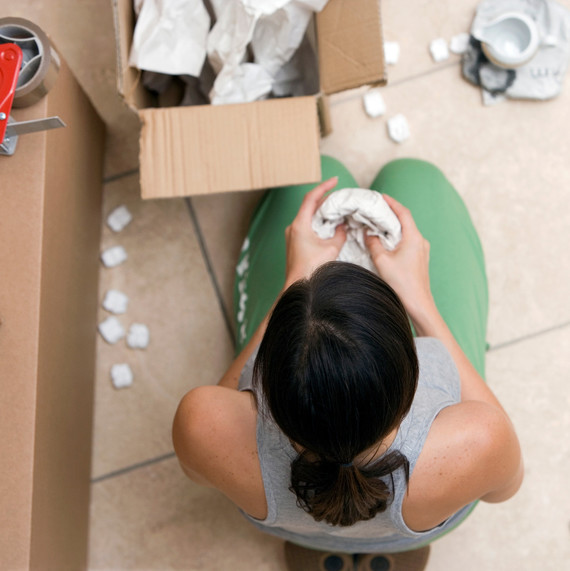 overhead of woman wrapping dishes overhead of woman wrapping dishes