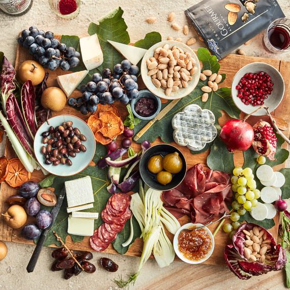serving board with almonds and meats olives pomegranate serving board with almonds and meats olives pomegranate