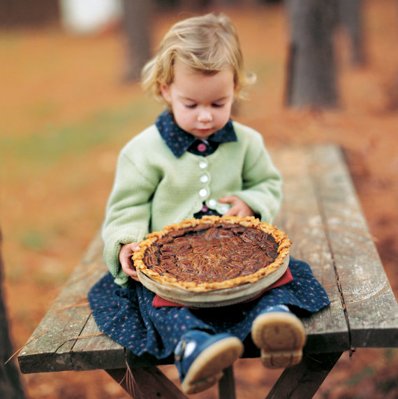 girl on picnic table holding pecan pie girl on picnic table holding pecan pie