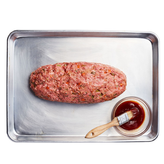 meatloaf on baking sheet ready to be glazed meatloaf on baking sheet ready to be glazed