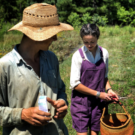vera holding basket gordon wearing hat in field vera holding basket gordon wearing hat in field