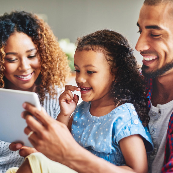 happy family looking at tablet happy family looking at tablet