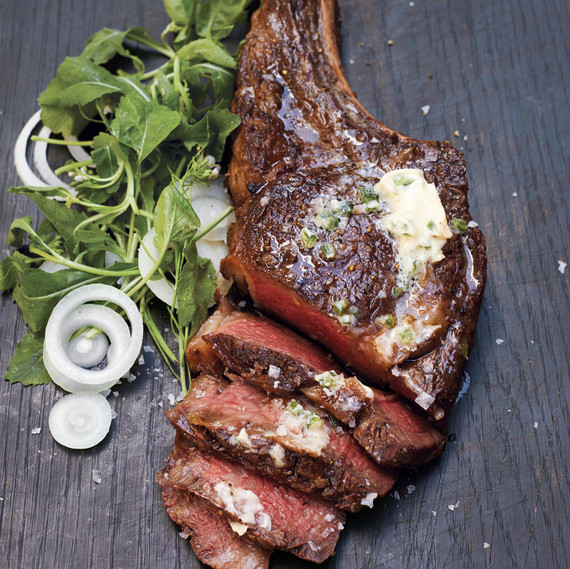 rib eye with jalapeno butter on a wooden surface rib eye with jalapeno butter on a wooden surface