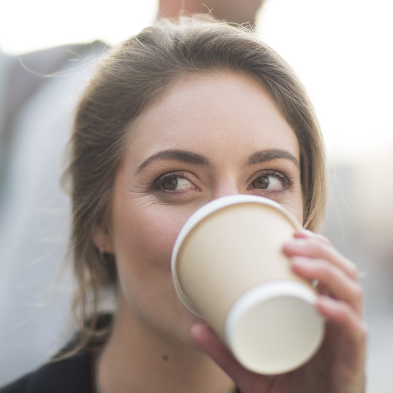 woman drinking to-go coffee woman drinking to-go coffee