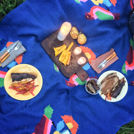 blue blanket used for picnic with peppers and grilled meat blue blanket used for picnic with peppers and grilled meat