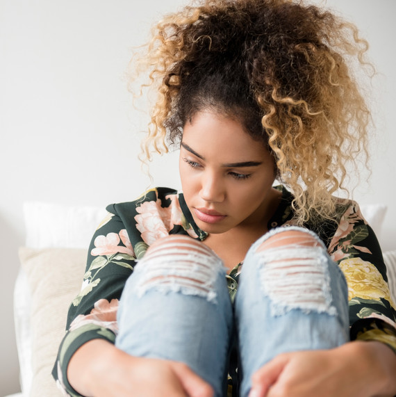 girl sitting on bed contemplating thoughts girl sitting on bed contemplating thoughts