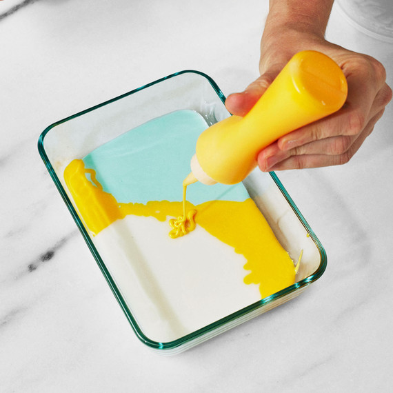 martha pouring yellow frosting into pyrex to make tie dye cookies martha pouring yellow frosting into pyrex to make tie dye cookies