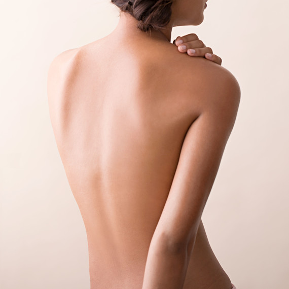 dry skin woman rubbing bare shoulder dry skin woman rubbing bare shoulder
