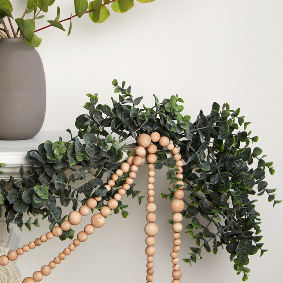 mantle white with wooden beaded garland and greenery