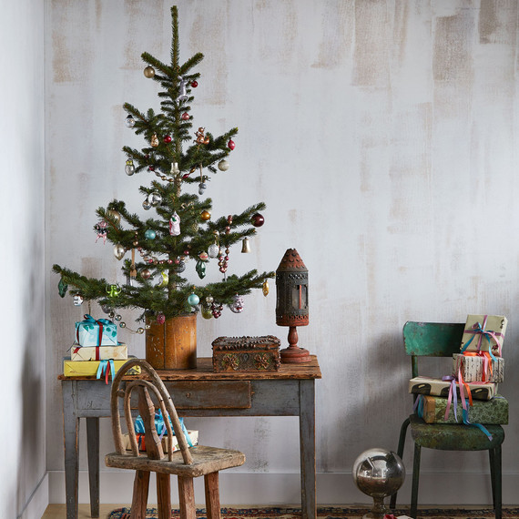 small christmas tree with vintage ornaments displayed among vintage furniture small christmas tree with vintage ornaments displayed among vintage furniture