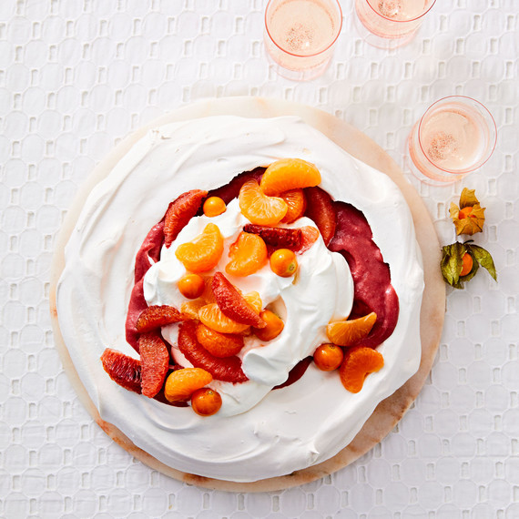 cranberry curd and citrus pavlova with sliced oranges cranberry curd and citrus pavlova with sliced oranges