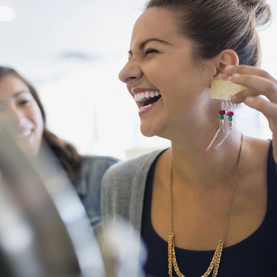 girl trying on earrings clothing swap girl trying on earrings clothing swap
